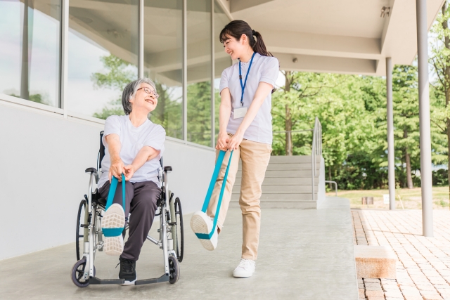 スタッフと高齢者が笑顔で楽しそうにレクリエーションを実施する写真